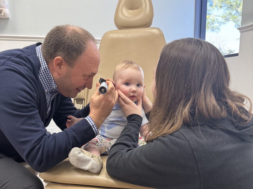 Dr. Sycamore examining a baby's ear